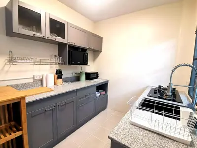 a kitchen with gray cabinets and a counter top at Kata beach Townhouse BL2 in Kata Beach
