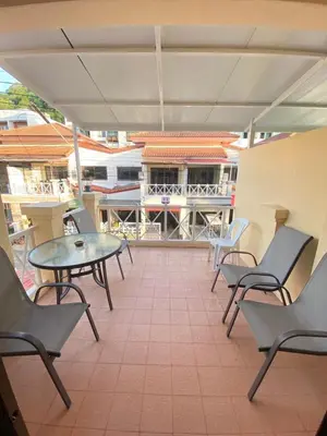 a patio with chairs and a table on a balcony at Kata beach Townhouse BL2 in Kata Beach