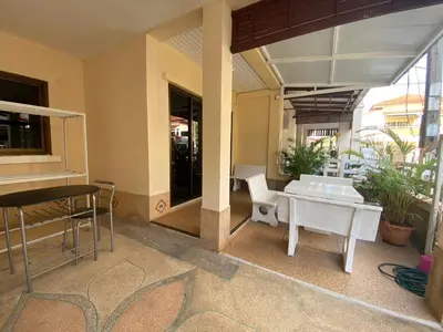 a room with a table and chairs in a building at Kata beach Townhouse BL2 in Kata Beach