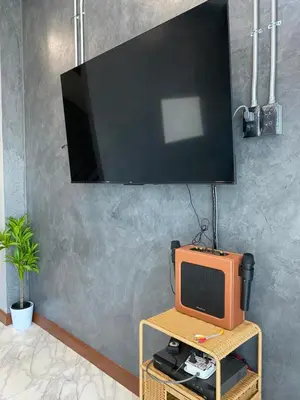 an orange tv sitting on a table in a room at Ta-iad homestay in Ban Suan