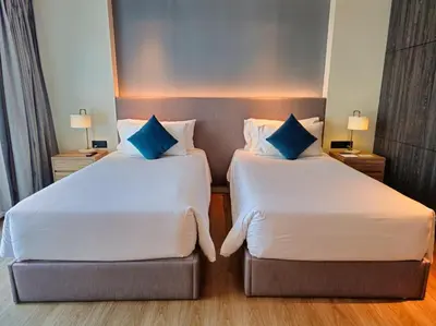 two beds sitting next to each other in a hotel room at Super Studio La Vita 2 pool in Rawai Beach