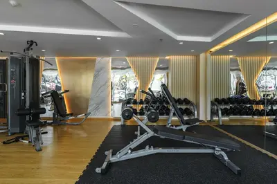 a gym with treadmills and machines in a room at Super Studio La Vita 2 pool in Rawai Beach