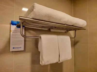a bathroom with white towels on a towel rack at Super Studio La Vita 2 pool in Rawai Beach