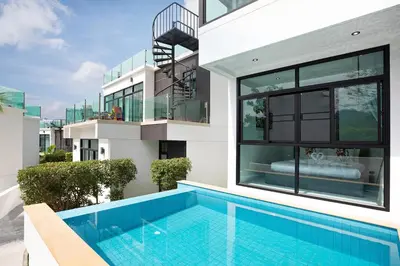 a house with a swimming pool in front of it at Namara The Residences B in Kamala Beach