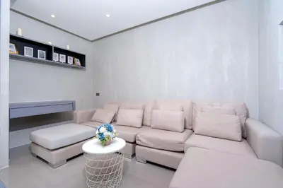 a living room with a couch and a table at Tropical Pool View 2 BR Apartment CTG B207-8 in Tropics Kamala Residence in Kamala Beach