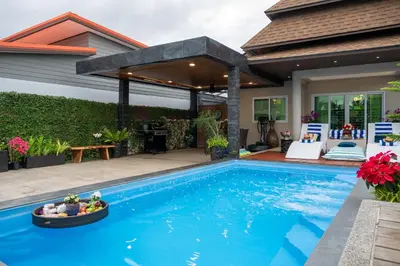 a swimming pool in front of a house at 2 bedrooms Amani Pool Villa Phuket in Thalang