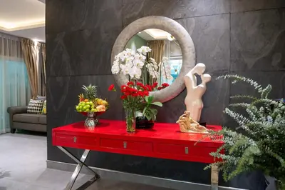 a room with a red table with flowers and a mirror at 2 bedrooms Amani Pool Villa Phuket in Thalang