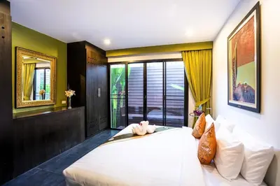 a bedroom with a large white bed with a window at 06 - Luxurious & Lavish Getaway in Surin Beach in Surin Beach