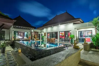 a villa with a swimming pool at night at 06 - Luxurious & Lavish Getaway in Surin Beach in Surin Beach