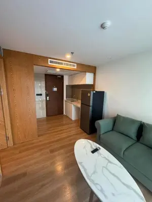 a living room with a couch and a surfboard at 2 bedrooms apartment La Vita Rawai in Rawai Beach