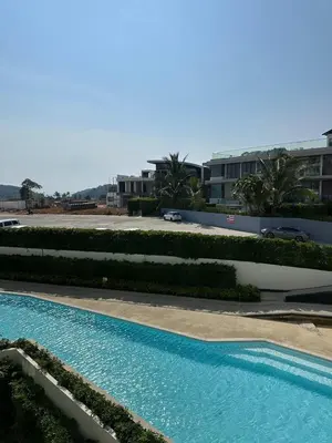a large swimming pool in front of a building at 2 bedrooms apartment La Vita Rawai in Rawai Beach