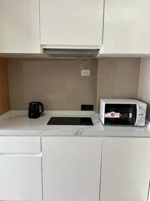a microwave sitting on top of a kitchen counter at 2 bedrooms apartment La Vita Rawai in Rawai Beach
