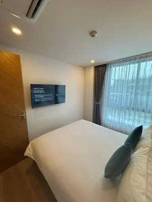 a bedroom with a large bed with a pillow on it at 2 bedrooms apartment La Vita Rawai in Rawai Beach