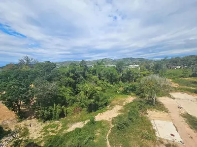 an overhead view of a forest of trees on a hill at Modern apartment Layan Beach in Layan Beach