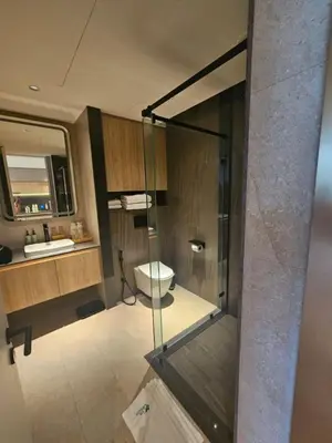 a bathroom with a glass shower and a toilet at Modern apartment Layan Beach in Layan Beach