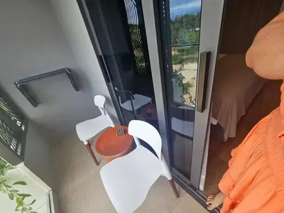 an aerial view of a room with two white chairs at Modern apartment Layan Beach in Layan Beach
