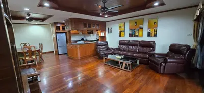 a living room with leather furniture and a kitchen at PATONG TOWER Big Family APARTMENTs 2026 Pta in Patong Beach