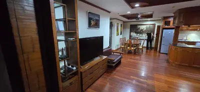a living room with a flat screen tv on a entertainment center at PATONG TOWER Big Family APARTMENTs 2026 Pta in Patong Beach