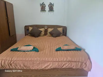 a bedroom with a bed with two towels on it at NW House in Ao Nang Beach