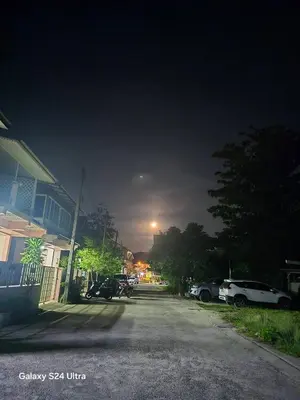 an empty street at night with the moon in the sky at NW House in Ao Nang Beach