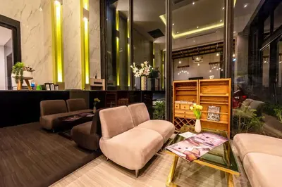 a lobby with a couch and a chair and a table at Peacefull new condo Patong in Patong Beach