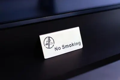 a sticker that says no smoking on a table at Baan Chom View Residences in Kamala Beach