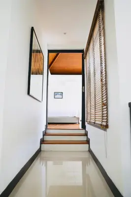 a staircase in a house with a window at Naiharn Beach 3 bedrooms villa in Rawai Beach
