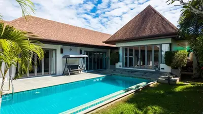 a house with a swimming pool in the yard at Naiharn Beach 3 bedrooms villa in Rawai Beach