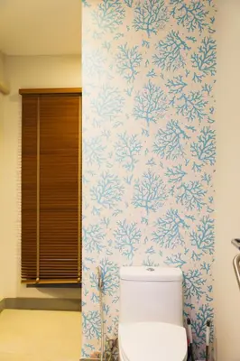 a toilet in a bathroom with blue and white wallpaper at Naiharn Beach 3 bedrooms villa in Rawai Beach