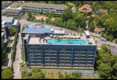 an overhead view of a large building with a swimming pool at Condo with Roof top sea view in Rawai Beach