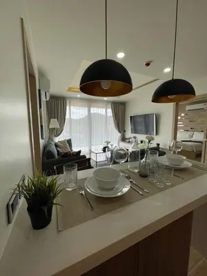 a kitchen with a counter with plates and glasses on it at Condo with Roof top sea view in Rawai Beach