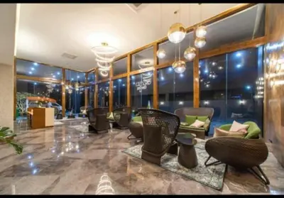 a lobby with chairs and tables in a building at Condo with Roof top sea view in Rawai Beach