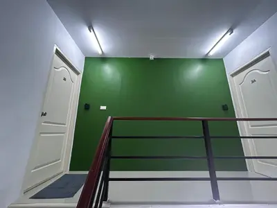 a room with a green wall and a staircase at Sleepwell at naiyang No2 in Nai Yang Beach