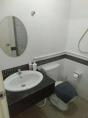 a bathroom with a sink and a toilet and a mirror at Sleepwell at naiyang No2 in Nai Yang Beach