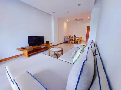 a living room with a couch and a tv at VIP Suite Residence At Tubkaak Beach, Krabi in Ban Ko Kwang