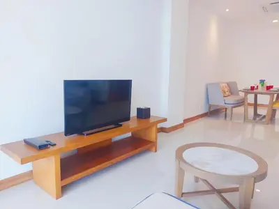 a living room with a flat screen tv on a wooden table at VIP Suite Residence At Tubkaak Beach, Krabi in Ban Ko Kwang