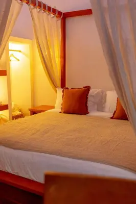 a bedroom with a white bed with a canopy at The beach house in Surin Beach