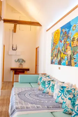 a room with a couch and a painting on the wall at The beach house in Surin Beach