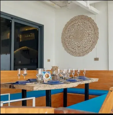 a table with wine glasses on top of it at The beach house in Surin Beach