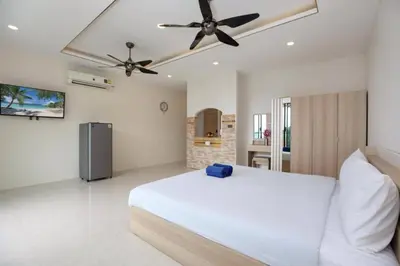 a bedroom with a white bed and a ceiling fan at Tropical Seaview Studio A601 at VV Patong, Just 5 Min Drive from Patong Nightlife in Patong Beach