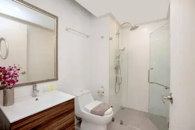 a white bathroom with a toilet and a shower at Tropical Seaview Studio A601 at VV Patong, Just 5 Min Drive from Patong Nightlife in Patong Beach