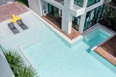 a swimming pool in front of a house at Tropical Seaview Studio A601 at VV Patong, Just 5 Min Drive from Patong Nightlife in Patong Beach