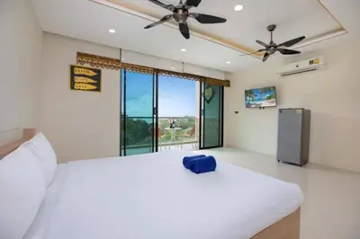 a bedroom with a white bed with a blue bag on it at Tropical Seaview Studio A601 at VV Patong, Just 5 Min Drive from Patong Nightlife in Patong Beach