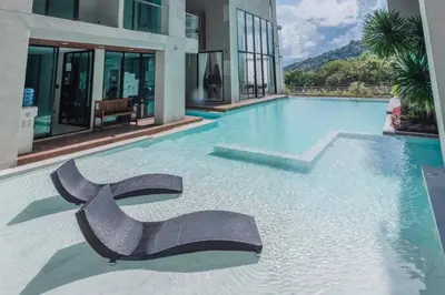 a swimming pool with a chair in the middle of a building at Tropical Seaview Studio A601 at VV Patong, Just 5 Min Drive from Patong Nightlife in Patong Beach