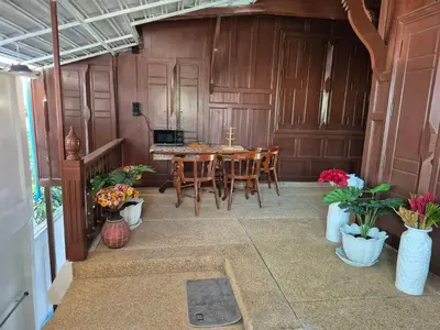a dining room with a table and chairs at Baan Nur Nur 201 in Surin Beach