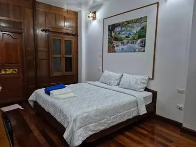 a bedroom with a bed with two towels on it at Baan Nur Nur 201 in Surin Beach