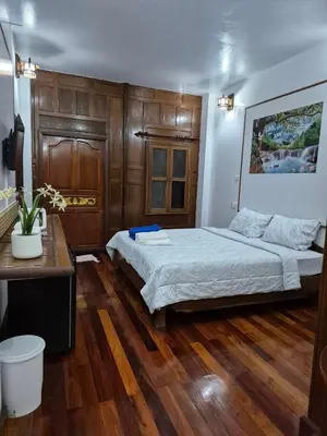 a bedroom with a bed and a wooden floor at Baan Nur Nur 201 in Surin Beach
