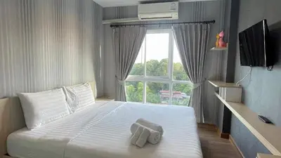 a bedroom with a white bed with a window at spacious and modern Apartment in Ao Nang in Ban Khlong Haeng