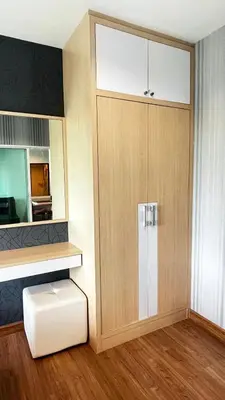 a room with a large wooden cabinet with a door at spacious and modern Apartment in Ao Nang in Ban Khlong Haeng