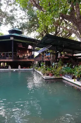 a pool of water in front of a restaurant at Tropical Hostel in Phi Phi Don
